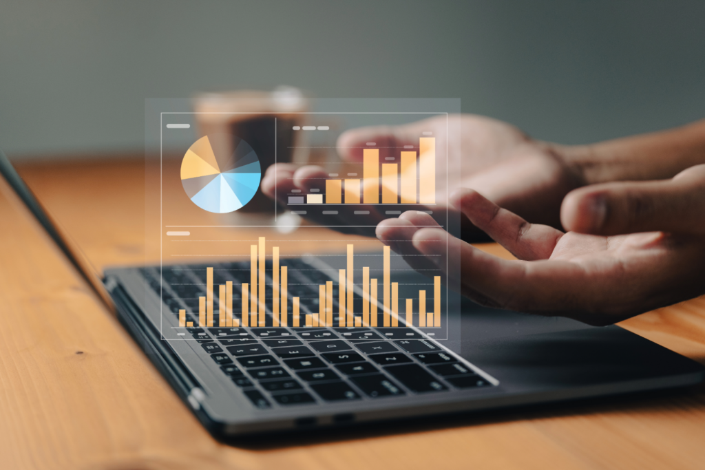 Businessman working on a laptop displaying graphs and bar charts, analyzing data for decision-making.